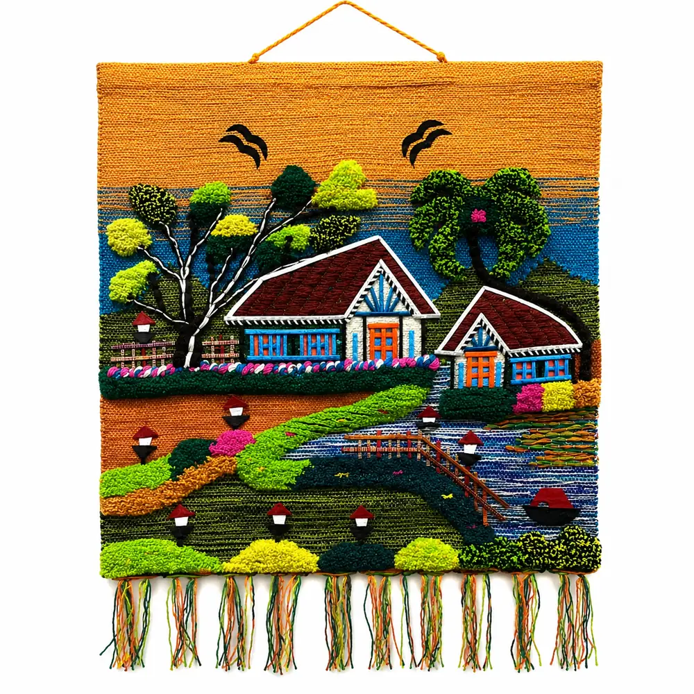 Hand-woven wall hanging with two cottages, a wooden bridge over the lake and tufted trees on an orange background