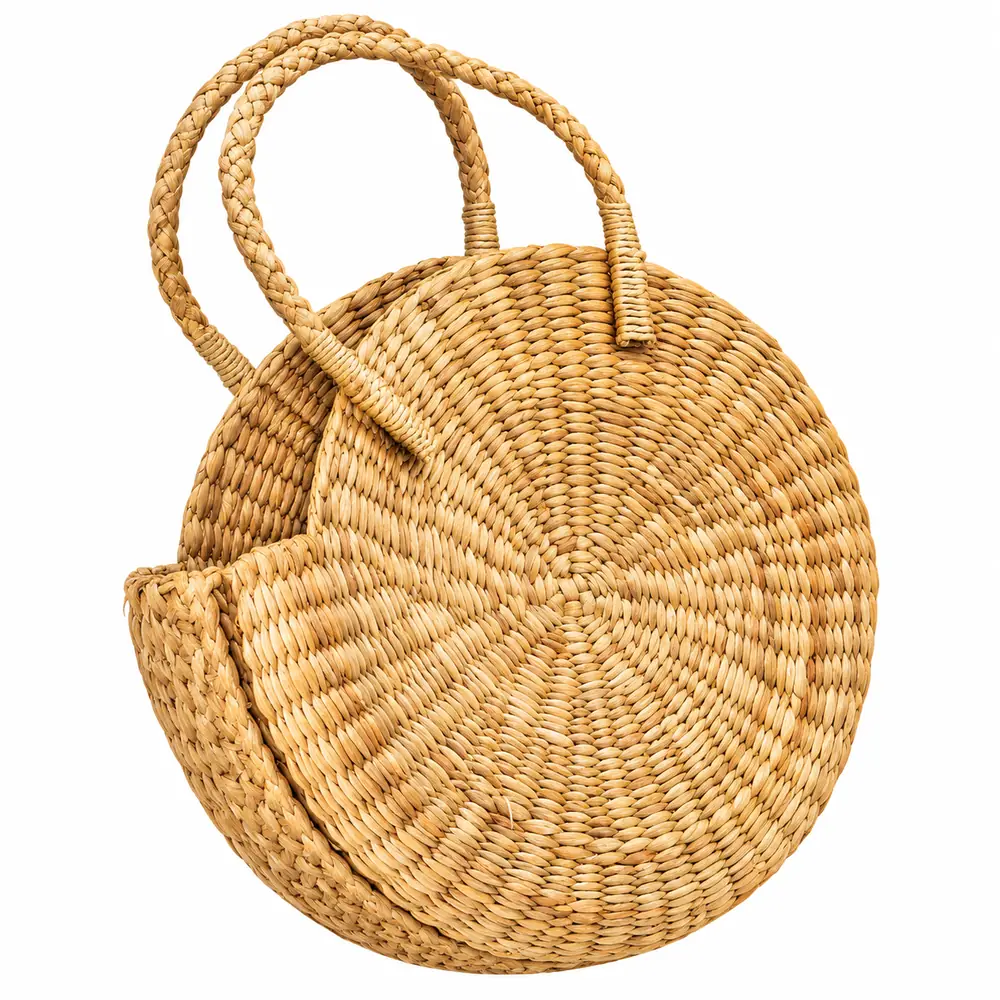 Angled view of a round water reed handbag showing the circular woven pattern and wrapped handle ends