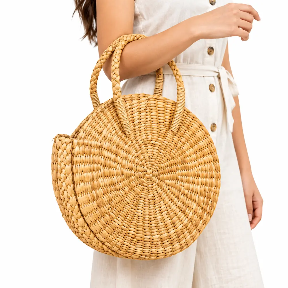 Woman carrying a handwoven water reed handbag for summer on her arm